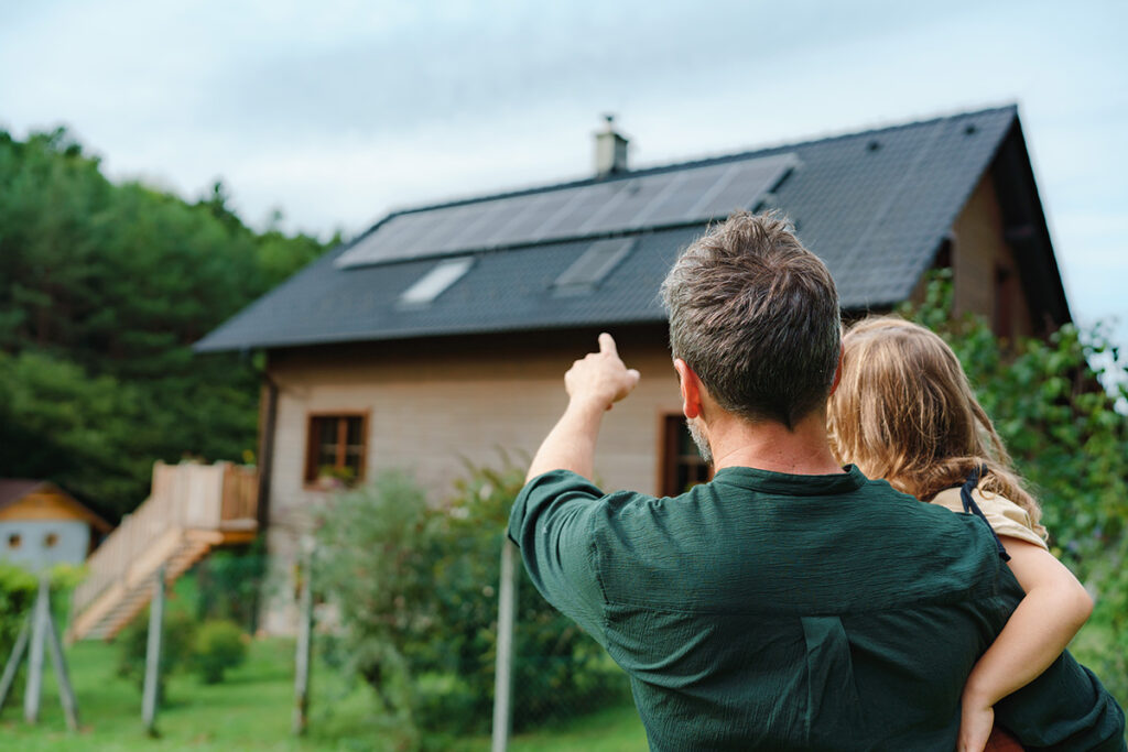 father and daughter with solar panels
